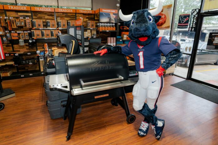 Texas Star Grill Shop - Texans Toro in Front of a Traeger Timberline