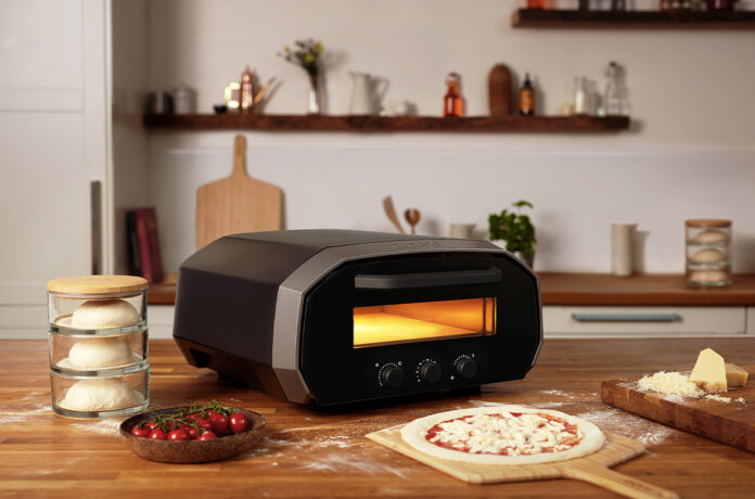 Ooni Volt 12 Pizza Oven on a Table with Pizza