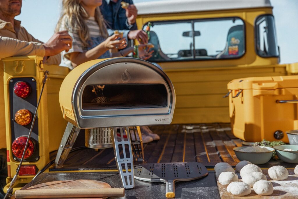 Yellow Gozney Roccbox on a Truck Bed