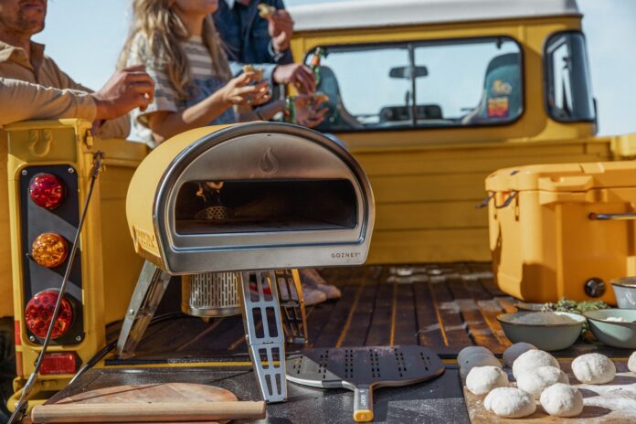 Yellow Gozney Roccbox on a Truck Bed