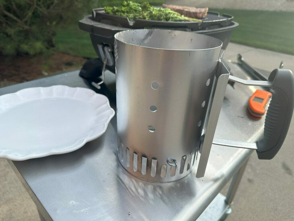 Weber Rapidfire Compact Chimney in front of a PKGO Grill