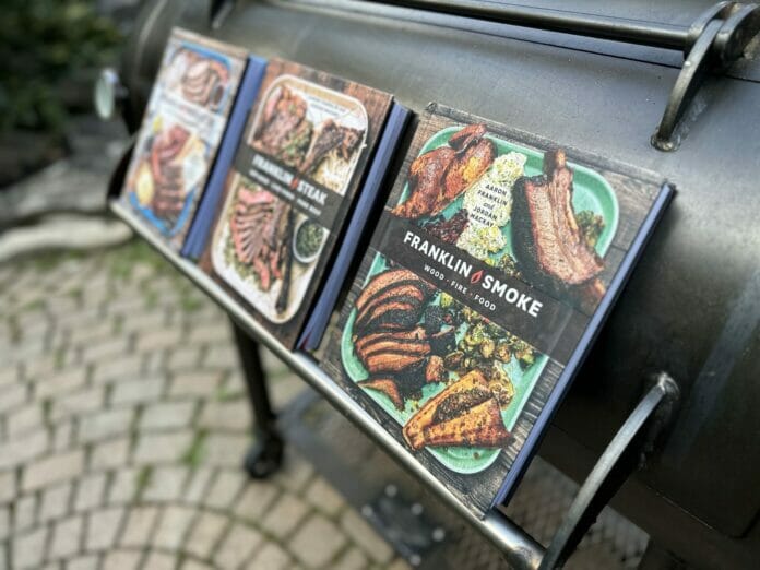 All Three Aaron Franklin Books on a Franklin Barbecue Pit