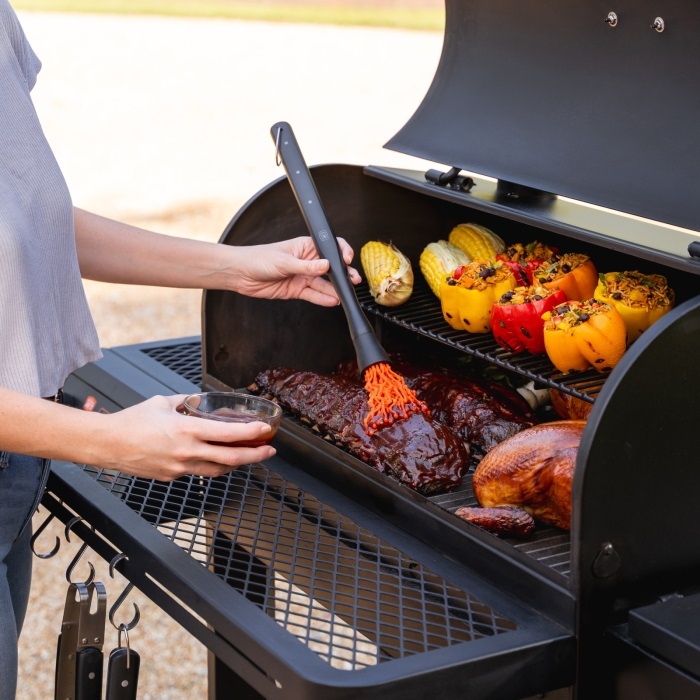 Oklahoma Joe's Tahoma Auto-Feed Charcoal Smoker Cooking Food