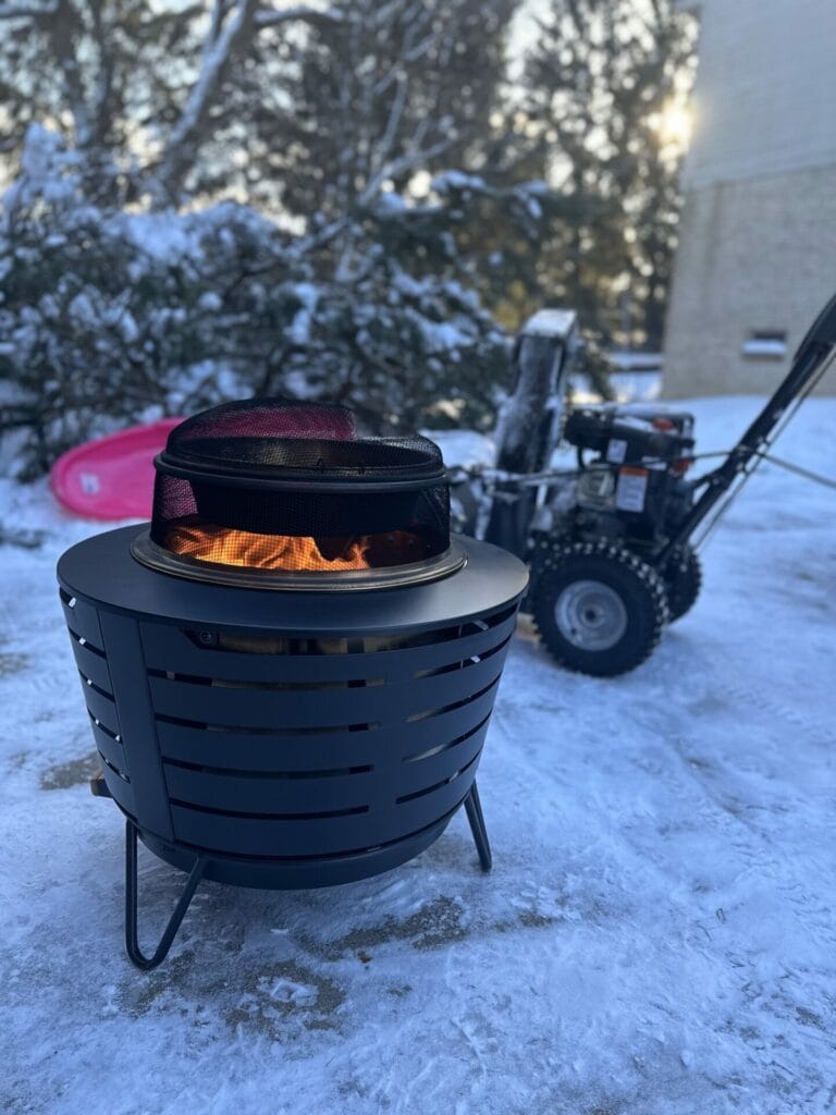 TIKI Fire Pit in Front of Snow Blower